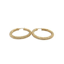 Load image into Gallery viewer, Bring elegant texture and timeless shine to your collection with these pre-owned 9ct yellow gold patterned twist hoop creole earrings, offering a sophisticated design and eye-catching detail — perfect for any occasion.

Design: These beautiful earrings feature a classic hoop creole shape with a graceful twist design, enhanced by subtle patterning that adds depth and refined character.
