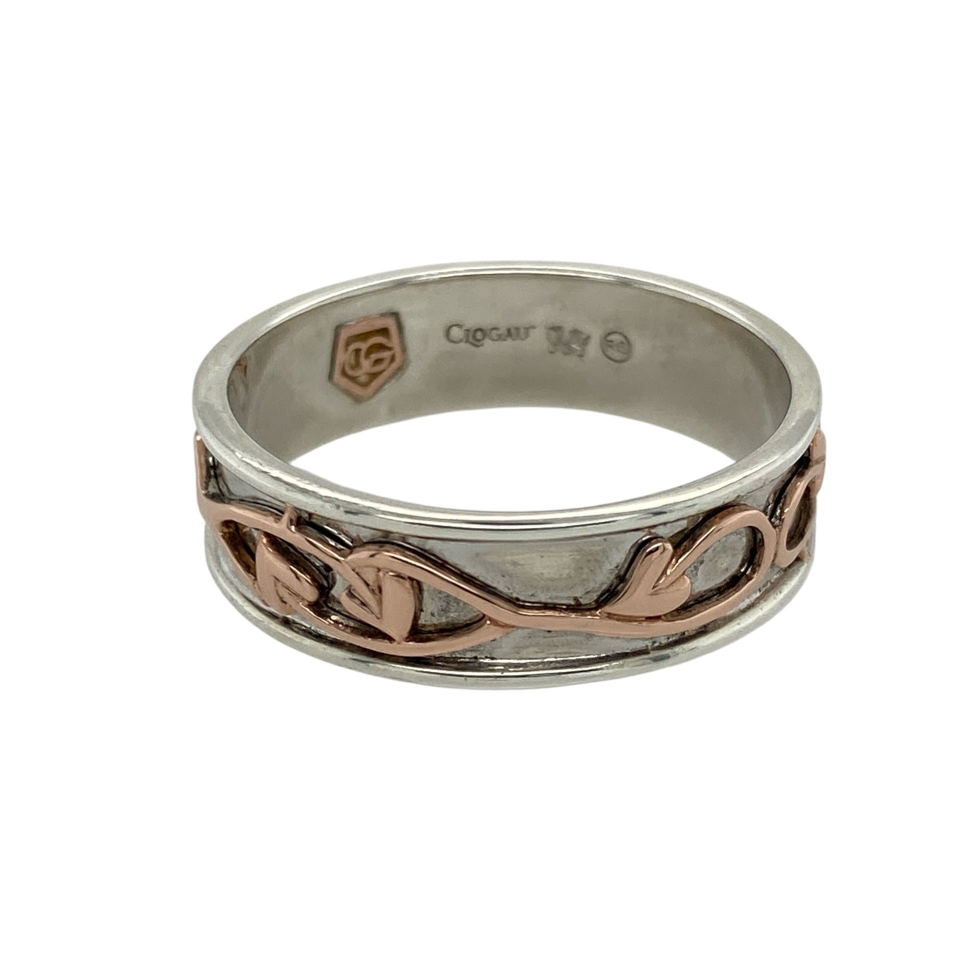 Bring timeless symbolism and bold elegance to your jewellery collection with this pre-owned 925 silver Clogau Tree of Life band ring, featuring 9ct rose gold detailing—perfect for marking life’s meaningful moments with enduring style.

Design: The 7mm wide band features the signature Tree of Life motif, with flowing vines in 9ct rose gold woven into the design to represent growth, strength, and connection.
