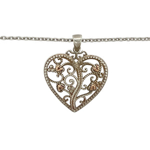 Bring romantic symbolism and graceful detail to your jewellery collection with this pre-owned 925 silver Clogau Tree of Life heart pendant necklace, detailed with 9ct rose gold—perfect for meaningful gifting or everyday elegance.

Design: The pendant measures 2.9cm long including the bail and features an open heart design adorned with flowing 9ct rose gold Tree of Life vines for a warm and intricate finish.
