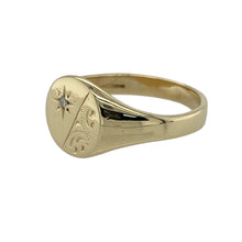 Load image into Gallery viewer, Bring timeless charm and refined sparkle to your jewellery collection with this pre-owned 9ct yellow gold patterned round diamond signet ring—perfect for adding elegance to a classic design.

Design: The ring features a 9mm high round face with fine patterned detailing and a central diamond for a subtle yet eye-catching finish.
Material: Made from 9-carat yellow gold, the polished surface enhances the warm golden tone and highlights the intricate design work.

