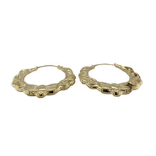 Load image into Gallery viewer, Bring bold elegance and intricate detail to your jewellery collection with these pre-owned 9ct yellow gold large fancy oval creole earrings—perfect for making a statement with timeless style.

Design: Each earring features a large oval creole shape with ornate fancy patterning, adding texture, depth, and visual interest.
Material: Made from 9-carat yellow gold, the polished finish enhances the warm golden tone and highlights the decorative detailing.

