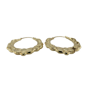 Bring bold elegance and intricate detail to your jewellery collection with these pre-owned 9ct yellow gold large fancy oval creole earrings—perfect for making a statement with timeless style.

Design: Each earring features a large oval creole shape with ornate fancy patterning, adding texture, depth, and visual interest.
Material: Made from 9-carat yellow gold, the polished finish enhances the warm golden tone and highlights the decorative detailing.
