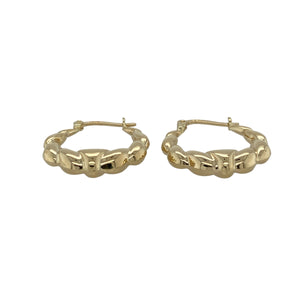 Bring playful texture and classic style to your jewellery collection with these pre-owned 9ct yellow gold bubble style oval creole earrings—perfect for adding subtle charm to everyday wear.

Design: Each earring features an oval creole shape with a raised bubble pattern, creating light-catching texture and a distinctive look.
Material: Made from 9-carat yellow gold, the polished finish enhances the warm golden tone and highlights the unique design.
