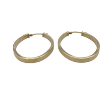Load image into Gallery viewer, Bring simple elegance and timeless style to your jewellery collection with these pre-owned 9ct yellow gold plain oval creole earrings—perfect for effortless everyday wear.

Design: Each earring features a smooth oval creole shape with a polished surface for a sleek and classic look.
Material: Made from 9-carat yellow gold, the polished finish enhances the warm golden tone.
Earring Detail: The hinged fastening ensures secure and comfortable wear, making them ideal for daily use.

