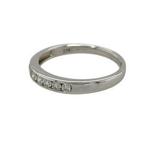 Bring refined sparkle and understated elegance to your jewellery collection with this pre-owned 9ct white gold diamond set band ring—perfect for stacking, everyday wear, or special occasions.

Design: The 3mm wide front is adorned with sparkling diamonds, adding subtle brilliance to the sleek band design.
Material: Made from 9-carat white gold, the polished finish enhances the cool, silvery tone and complements the diamonds beautifully.
