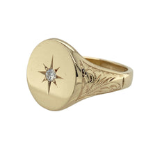 Load image into Gallery viewer, Bring bold style and refined sparkle to your collection with this pre-owned 9ct yellow gold diamond oval signet ring—perfect for making a confident statement or adding a touch of luxury to everyday wear.

Design: The ring features a 16mm high oval-shaped front with a central diamond in a starburst setting, adding both brilliance and vintage-inspired detail.
Material: Made from 9-carat yellow gold, the polished surface enhances the warm tone and highlights the intricate starburst design.

