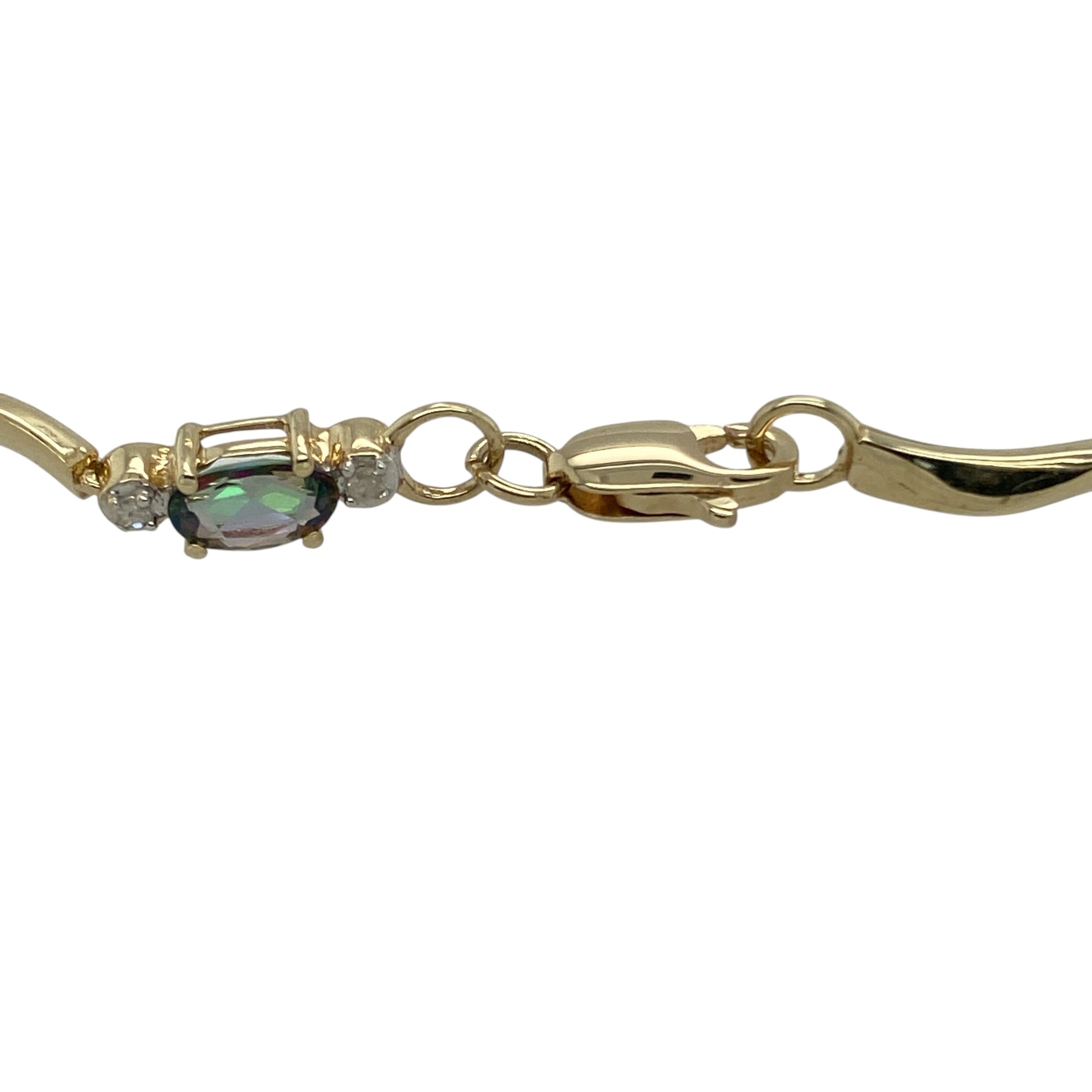 Bring vibrant colour and sparkling detail to your collection with this pre-owned 9ct yellow gold bracelet, styled with mystic topaz and diamond accents.

Design: The 7.5" bracelet is set with oval mystic topaz stones, each measuring 5mm by 3mm, interspersed with diamond accents for added brilliance.
Material: Made from 9-carat yellow gold, the polished finish enhances the warm tone and beautifully frames the colourful gemstones.
