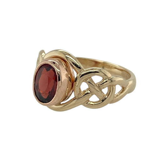 Bring rich colour and traditional symbolism to your jewellery collection with this pre-owned 9ct yellow and rose gold Clogau garnet Celtic ring — a meaningful piece with warm tones and timeless character.

Design: The ring features a 7mm by 5mm oval garnet at the centre, showcased within an elegant Celtic-inspired pattern that reflects heritage and artistry.
Material: Made from 9ct yellow and rose gold, the combination of metals enhances the depth of the garnet and adds a distinctive, decorative contrast.