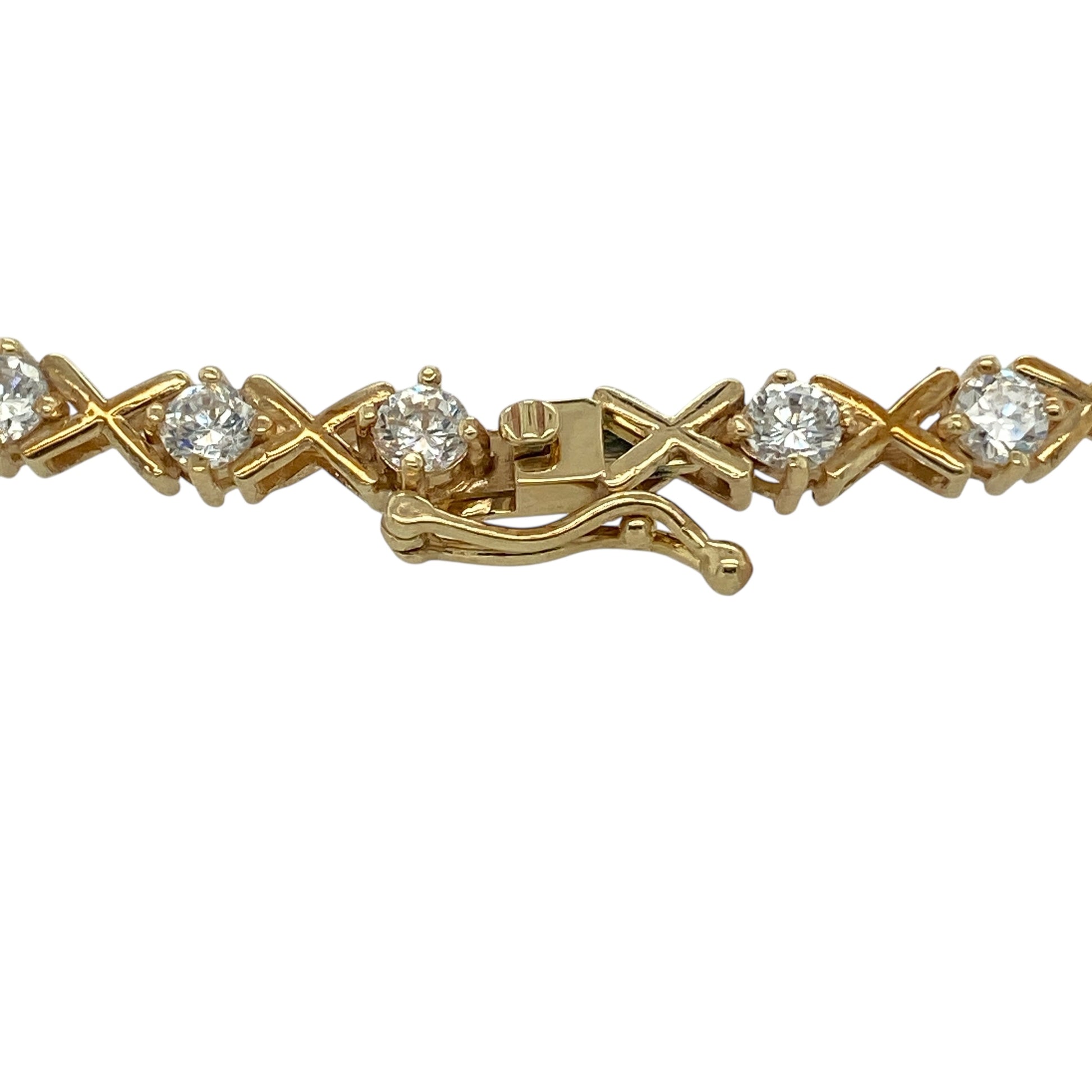 Bring sparkle, elegance, and warm golden shine to your jewellery collection with this pre-owned 9ct yellow gold and cubic zirconia 7" bracelet—an eye-catching piece that blends timeless style with radiant brilliance.

Design: This beautifully arranged bracelet features alternating 3mm cubic zirconia stones and stylish ‘X’ kiss-shaped links, creating a flowing pattern that catches the light with every movement. The combination of sparkle and polished gold offers a refined yet contemporary look.