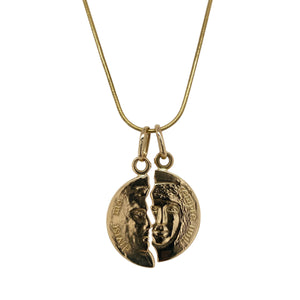 Celebrate connection and enduring love with this pre-owned 18ct gold 'Friend/Lover' moon love necklace, featuring:

Design: A symbolic pair of disc-style pendants, each with a sculpted face and a jagged edge that fits perfectly with the other—representing two halves of a whole. Inscribed with "divisi ma sempre uniti" (“separated but always united”), this piece is rich in sentiment and artistic detail.
Material: 18-carat gold, offering a luxurious, warm tone with a high-polish finish.
