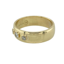 Load image into Gallery viewer, Add a touch of timeless sophistication to your collection with this pre-owned 14ct yellow gold diamond set band ring, featuring a classic design with a graceful arrangement of diamonds, perfect for everyday elegance or marking a special moment:

Design: A wide band style with three brilliant-cut diamonds set across the front—featuring a slightly larger centre stone flanked by two smaller diamonds for a balanced and elegant look.
Material: Made from 14-carat yellow gold
