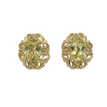 Load image into Gallery viewer, Add vibrant colour and elegant sparkle to your collection with these pre-owned 9ct yellow gold peridot-coloured green stone and cubic zirconia set fancy stud earrings—perfect for refined glamour with a lively twist.

Design: Each earring features an 8mm by 6mm oval green stone in a peridot hue, accented by sparkling cubic zirconia for a bright, eye-catching finish.
Material: Made from 9-carat yellow gold, the polished setting enhances the vivid green tones and the brilliance of the surrounding stones.

