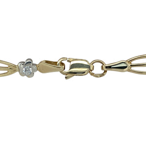Bring floral sparkle and two-tone elegance to your collection with this pre-owned 9ct yellow and white gold bracelet set with cubic zirconia—a delicate design with timeless charm.

Design: This 7.5" bracelet features alternating yellow and white gold flower links, each set with a sparkling cubic zirconia, creating a graceful and feminine look.
Material: Made from 9-carat yellow and white gold, the polished finish highlights the contrast between metals and enhances the brilliance of the stones.
