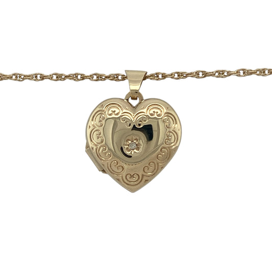 Bring sentimental charm and classic elegance to your collection with this pre-owned 9ct yellow gold diamond patterned heart locket on an 18" Prince of Wales chain, a meaningful piece designed to keep memories close.

Design: The locket pendant measures 2.5cm long including the bail and is styled in a heart shape with a decorative patterned finish, accented by sparkling diamonds for added brilliance.