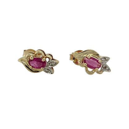 Bring classic colour and delicate sparkle to your jewellery collection with these pre-owned 9ct yellow gold diamond & ruby set flower style stud earrings, a timeless and elegant design.

Design: Each stud features a floral-inspired arrangement centred with an oval ruby measuring 5mm by 3mm, creating a rich red focal point accented by diamonds for added brilliance.
Material: Made from polished 9-carat yellow gold, the warm tone beautifully enhances the deep hue of the rubies and the sparkle of the diamonds.
