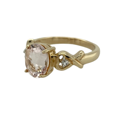 Bring soft blush tones and refined sparkle to your jewellery collection with this pre-owned 9ct yellow gold morganite and white topaz set ring, a graceful design with timeless elegance.

Design: This ring features a delicate oval morganite at the centre, complemented by white topaz accents that enhance the stone’s gentle pink hue and add subtle brilliance.