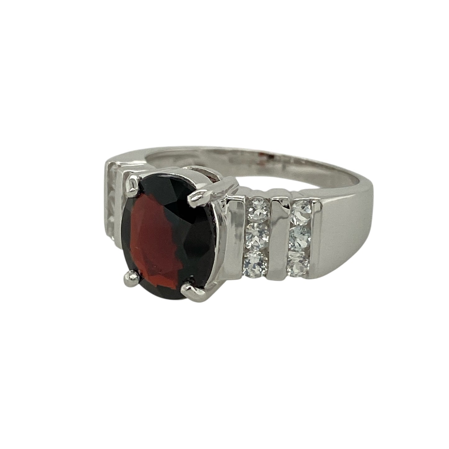 Bring warm colour and refined sparkle to your jewellery collection with this pre-owned 9ct white gold spessartite garnet and white topaz set ring.

Design: The ring features an oval spessartite garnet at the centre, measuring approximately 10mm by 8mm, surrounded by bright white topaz accents that highlight its rich orange tones.
Material: Made from 9-carat white gold, the polished finish provides a striking contrast to the vivid colour of the garnet and enhances the brilliance of the white topaz.
