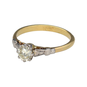 Preowned 18ct Yellow and White Gold & Diamond Set Solitaire Ring in size M with the weight 2.30 grams. The diamond is brilliant cut and is approximate clarity Si1 and colour M - R