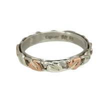 Load image into Gallery viewer, Add a sentimental and elegant touch to your jewellery collection with this pre-owned 925 silver Clogau with 9ct rose gold Clogau Tree of Life Cariad band ring.

Design: This ring features the iconic Tree of Life design, symbolizing growth, strength, and connection, paired with the delicate 9ct rose gold accents. The word &quot;Cariad,&quot; meaning &quot;love&quot; in Welsh, is engraved on the side, making this a meaningful piece for any wearer.

