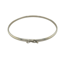 Load image into Gallery viewer, Bring sleek elegance and timeless simplicity to your collection with this pre-owned 9ct white gold plain bangle, offering a versatile design with refined style—perfect for everyday wear or layering.

Design: The bangle measures 6cm in diameter with a 3mm width, creating a smooth and minimal profile for a classic look.
Material: Made from solid 9-carat white gold, the polished finish enhances the bangle with a bright, modern shine.


