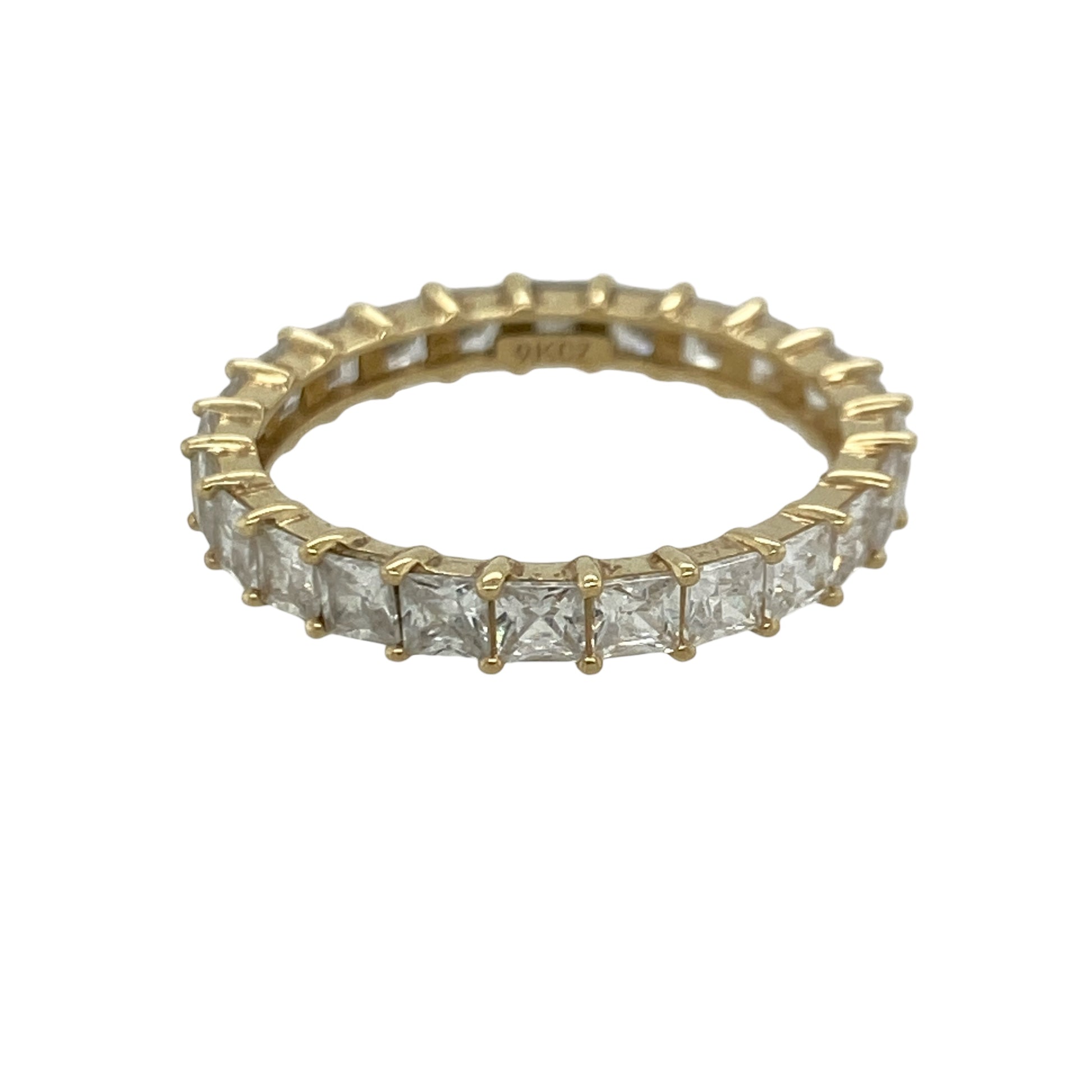 Add timeless sparkle and contemporary elegance to your jewellery collection with this pre-owned 9ct yellow gold cubic zirconia eternity band ring, featuring a striking full eternity design with brilliant square-cut stones—perfect for stacking, gifting, or celebrating a special occasion.

Design: The ring features sparkling square-cut cubic zirconia stones set around the entire band, creating a continuous display of brilliance and a sophisticated geometric look.