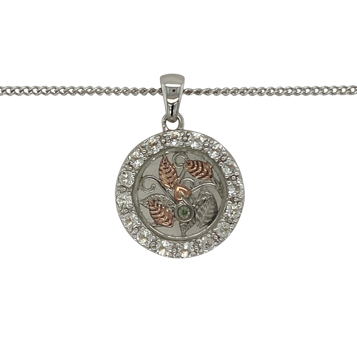 Celebrate nature-inspired beauty and Welsh elegance with this pre-owned 925 silver and 9ct rose gold Clogau white topaz leaf style pendant necklace. Featuring an intricate circular leaf design accented with sparkling white topaz, this eye-catching necklace combines timeless symbolism with the distinctive styling of Clogau jewellery.

Design: The pendant showcases a beautifully detailed round leaf-inspired motif, symbolising growth, renewal, and natural beauty.