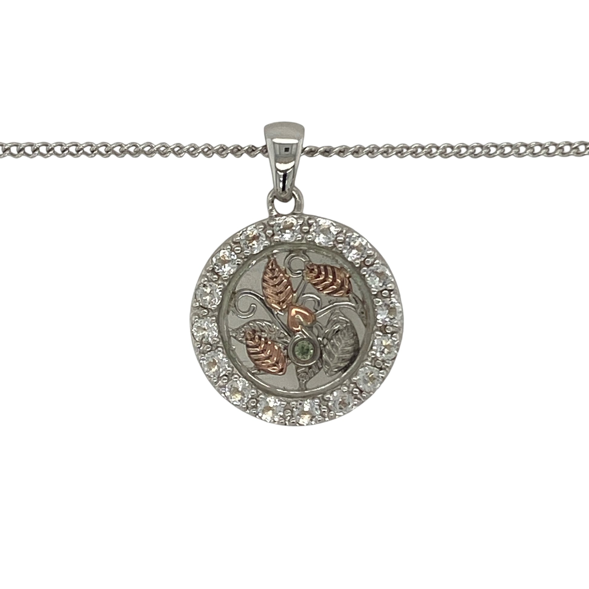 Celebrate nature-inspired beauty and Welsh elegance with this pre-owned 925 silver and 9ct rose gold Clogau white topaz leaf style pendant necklace. Featuring an intricate circular leaf design accented with sparkling white topaz, this eye-catching necklace combines timeless symbolism with the distinctive styling of Clogau jewellery.

Design: The pendant showcases a beautifully detailed round leaf-inspired motif, symbolising growth, renewal, and natural beauty.