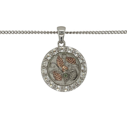 Celebrate nature-inspired beauty and Welsh elegance with this pre-owned 925 silver and 9ct rose gold Clogau white topaz leaf style pendant necklace. Featuring an intricate circular leaf design accented with sparkling white topaz, this eye-catching necklace combines timeless symbolism with the distinctive styling of Clogau jewellery.

Design: The pendant showcases a beautifully detailed round leaf-inspired motif, symbolising growth, renewal, and natural beauty.