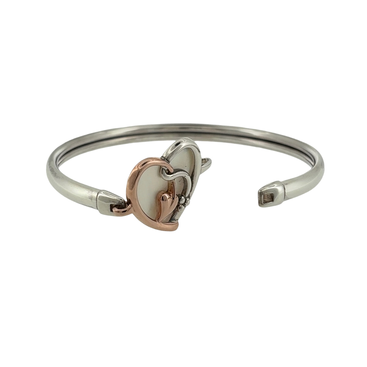 Add a meaningful and elegant piece to your jewellery collection with this pre-owned Clogau Tree of Life heart bangle, combining 925 sterling silver, 9ct rose gold and mother of pearl in a beautiful symbolic design.

Design: The bangle features a decorative heart design incorporating the iconic Tree of Life motif, creating an attractive and sentimental appearance inspired by nature.
Material: Made from 925 sterling silver with 9ct rose gold detailing, offering an elegant contrasting two-tone finish.