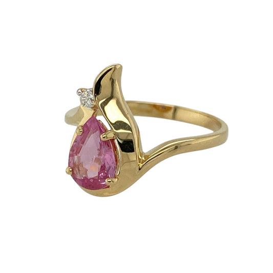 Bring soft colour and elegant sparkle to your jewellery collection with this pre-owned 18ct yellow gold diamond and pink sapphire set teardrop ring, offering a graceful design with refined contrast—perfect for special occasions or statement wear.

Design: The ring features a teardrop-shaped pink sapphire at the centre measuring approximately 8mm by 6mm, complemented by diamond accents that enhance the shape and add delicate brilliance.