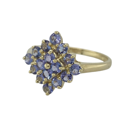 Bring rich colour and elegant presence to your jewellery collection with this pre-owned 9ct yellow gold tanzanite set cluster ring, offering a classic design with striking scale—perfect for special occasions or statement wear.

Design: The ring features a cluster arrangement of tanzanite stones, each measuring approximately 2.5mm in diameter, forming a bold focal point. The front of the ring measures approximately 15mm in height, giving it an eye-catching and elegant profile.