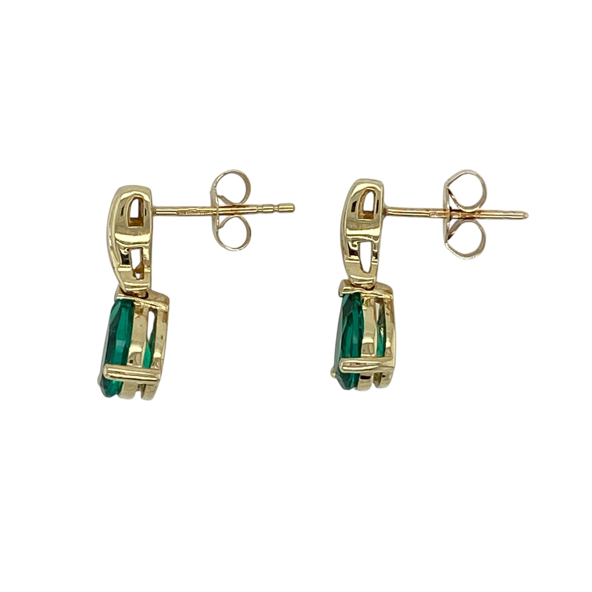 Add elegant colour and graceful movement to your jewellery collection with this pre-owned 9ct yellow gold diamond and emerald coloured stone set drop stud earrings, offering a refined design with eye-catching sparkle—perfect for special occasions or polished everyday wear.

Design: The earrings feature classic stud tops accented with diamond detailing, leading to teardrop-shaped emerald coloured stones measuring approximately 8mm by 6mm, creating a beautiful drop silhouette.