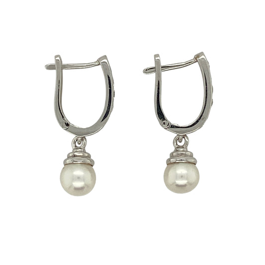 Bring timeless elegance and soft lustre to your jewellery collection with this pre-owned 18ct white gold diamond and pearl drop huggie earrings, combining classic refinement with graceful movement—perfect for special occasions or elevated everyday wear.

Design: The earrings feature diamond-accented huggie hoops with elegant pearl drops, each pearl measuring approximately 6mm in diameter, creating a delicate and sophisticated silhouette.
