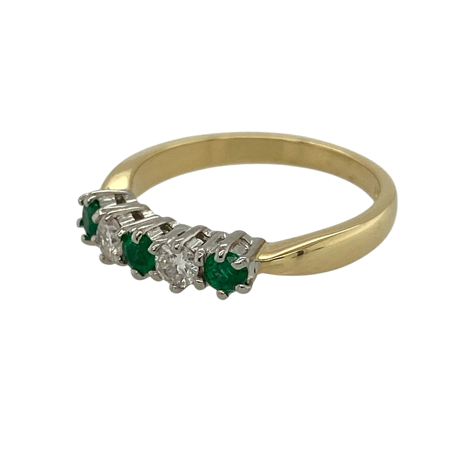 Add refined colour and classic elegance to your jewellery collection with this pre-owned 18ct yellow gold diamond and emerald set band ring, offering a timeless design with delicate sparkle—perfect for everyday wear or special occasions.

Design: The ring features three round emerald stones, each measuring approximately 3mm in diameter, with a sparkling diamond set between each emerald, creating a balanced and elegant band-style arrangement.