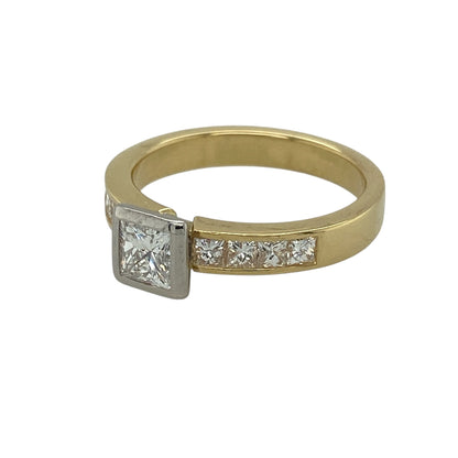 Bring striking sparkle and classic elegance to your jewellery collection with this pre-owned 18ct yellow gold and diamond set princess cut solitaire ring, offering a bold centre stone enhanced by diamond-set shoulders—perfect for special occasions or an engagement ring.

Design: The ring features a central princess-cut diamond with an approximate weight of 0.44ct, complemented by smaller diamonds set along the band, creating a beautifully balanced and eye-catching look.