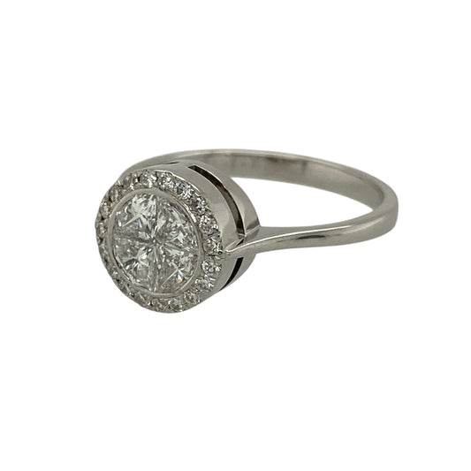 Add exceptional sparkle and elegant presence to your jewellery collection with this pre-owned 18ct white gold and diamond set halo illusion ring, offering a luxurious design with striking brilliance—perfect for special occasions or as a statement engagement ring.

Design: The ring features an illusion-set arrangement of four diamonds forming the appearance of a single round diamond, surrounded by a halo of smaller diamonds to maximise sparkle and visual impact.