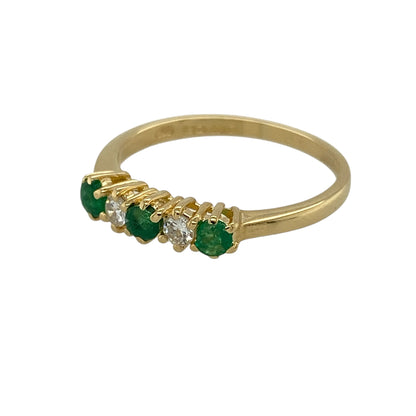 Add refined colour and timeless elegance to your jewellery collection with this pre-owned 18ct yellow gold diamond and emerald set band ring, offering a delicate design with classic appeal—perfect for everyday wear or special occasions.

Design: The ring features small round emerald stones, each measuring approximately 2mm in diameter, accented with diamond detailing for subtle sparkle and balance.