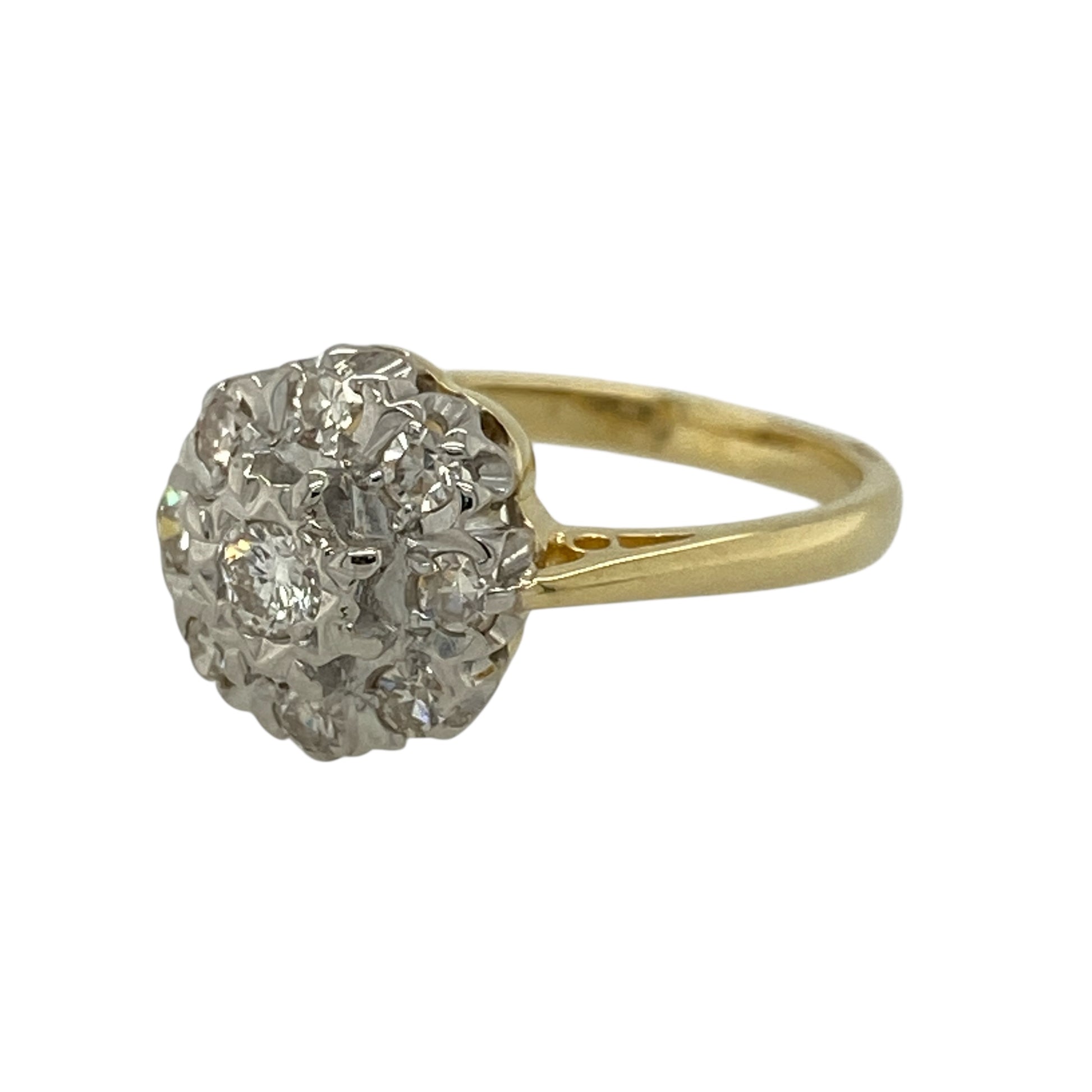 Add timeless floral elegance and vintage charm to your jewellery collection with this pre-owned 18ct yellow gold and diamond set vintage flower cluster ring, offering classic design with beautiful sparkle—perfect for special occasions or collectors of vintage jewellery.

Design: The ring features a flower-inspired cluster arrangement forming a striking front measuring approximately 10mm in height, creating an elegant and eye-catching focal point.