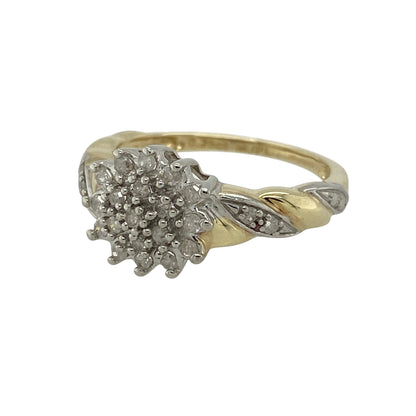 Add elegant sparkle and flowing detail to your jewellery collection with this pre-owned 9ct yellow and white gold and diamond set cluster ring, featuring twist-style shoulders and a timeless two-tone finish—perfect for special occasions or everyday elegance.

Design: The ring showcases a classic diamond cluster forming a striking front measuring approximately 10mm in height, framed by graceful twist-style shoulders that add movement and visual interest.