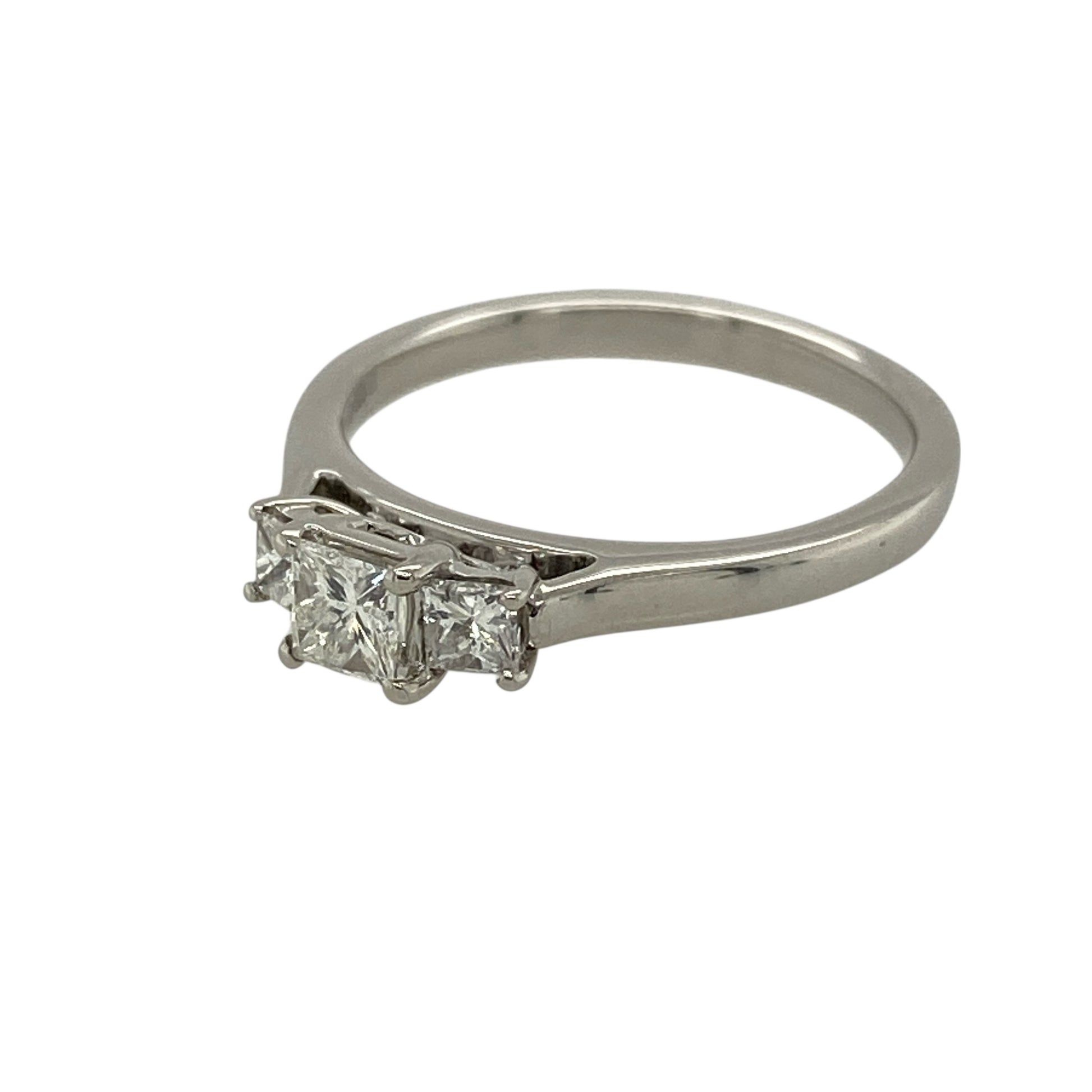 Add striking brilliance and timeless elegance to your jewellery collection with this pre-owned 18ct white gold and diamond set trilogy ring, offering a classic design with exceptional sparkle—perfect for engagements or meaningful gifting.

Design: The ring features a princess-cut diamond trilogy arrangement, with a central diamond of approximately 0.35ct flanked by two matching diamonds of approximately 0.10ct each, creating a beautifully balanced and impactful look.
