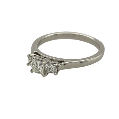 Add striking brilliance and timeless elegance to your jewellery collection with this pre-owned 18ct white gold and diamond set trilogy ring, offering a classic design with exceptional sparkle—perfect for engagements or meaningful gifting.

Design: The ring features a princess-cut diamond trilogy arrangement, with a central diamond of approximately 0.35ct flanked by two matching diamonds of approximately 0.10ct each, creating a beautifully balanced and impactful look.
