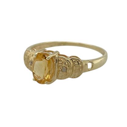 Add warm colour and delicate sparkle to your jewellery collection with this pre-owned 9ct yellow gold diamond and citrine set ring, offering a refined design with timeless appeal—perfect for everyday wear or special occasions.

Design: The ring features a central oval citrine stone measuring approximately 7mm by 5mm, creating a bright and elegant focal point, complemented by diamond-set shoulders.