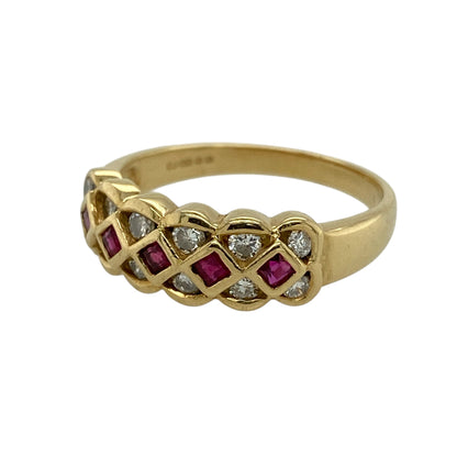 Add rich colour and elegant detail to your jewellery collection with this pre-owned 18ct yellow gold diamond and ruby lattice design band ring, offering a striking look with classic appeal.

Design: This band ring features a decorative lattice-style front measuring approximately 7mm in width, showcasing a combination of rubies and diamonds arranged to create depth, texture, and visual interest.
