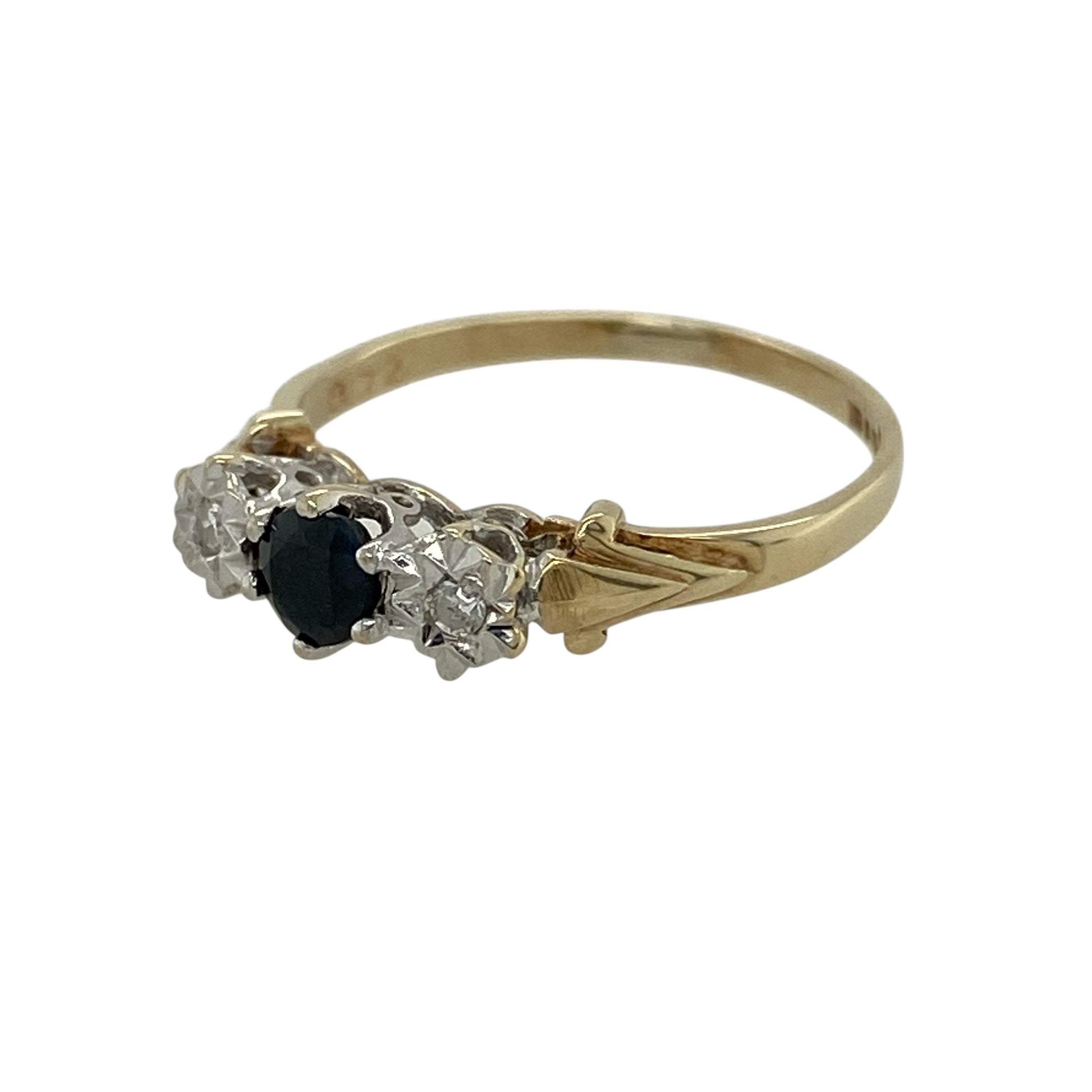 Add classic colour and meaningful sparkle to your jewellery collection with this pre-owned 9ct yellow gold diamond and sapphire trilogy ring, offering timeless design in a delicate form.

Design: This ring features a trilogy arrangement with a round sapphire at the centre measuring approximately 4mm in diameter, flanked by an illusion-style diamond on either side to enhance sparkle and visual balance.