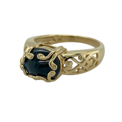 Add flowing elegance and rich colour to your jewellery collection with this pre-owned 9ct yellow gold blue stone swirl detail ring, offering a bold yet graceful design.

Design: This ring features an oval blue stone measuring approximately 7mm by 9mm, framed by a flowing swirl detail that creates movement and visual interest across the front.
Material: Made from 9-carat yellow gold, the warm polished finish beautifully complements the vibrant blue tone of the stone and enhances the fluid design.