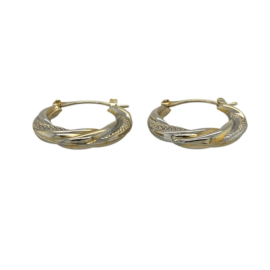 Add elegant contrast and classic texture to your jewellery collection with this pre-owned 9ct yellow and white gold patterned twisted hoop creole earrings, offering timeless two-tone appeal.

Design: These creole earrings feature a twisted hoop shape with a patterned finish, combining yellow and white gold tones to create subtle contrast and visual interest.
