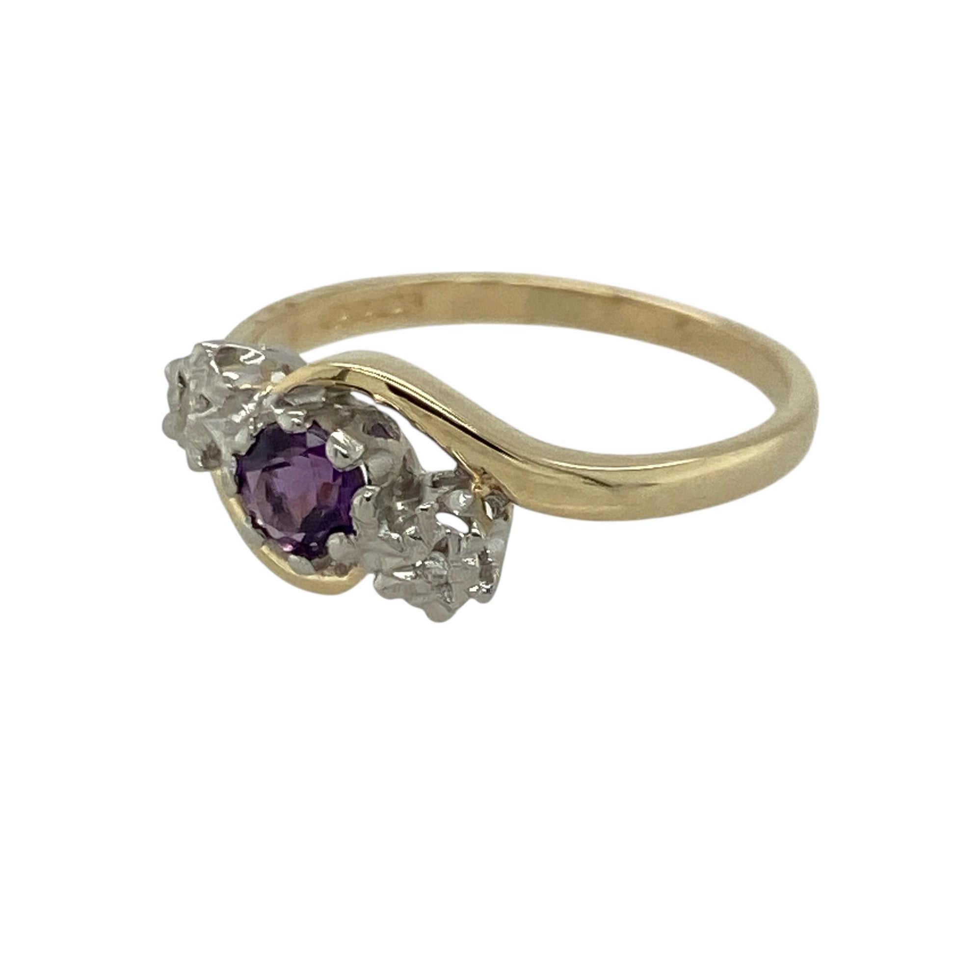 Add graceful colour and elegant sparkle to your jewellery collection with this pre-owned 9ct yellow gold diamond and amethyst trilogy twist ring, offering a refined design with timeless appeal.

Design: This ring features a trilogy-style arrangement with a round amethyst at the centre measuring approximately 4mm in diameter, framed by illusion-style diamonds on either side for enhanced sparkle and balance. The gentle twist design adds movement and elegance to the overall look.