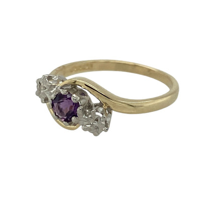 Add graceful colour and elegant sparkle to your jewellery collection with this pre-owned 9ct yellow gold diamond and amethyst trilogy twist ring, offering a refined design with timeless appeal.

Design: This ring features a trilogy-style arrangement with a round amethyst at the centre measuring approximately 4mm in diameter, framed by illusion-style diamonds on either side for enhanced sparkle and balance. The gentle twist design adds movement and elegance to the overall look.