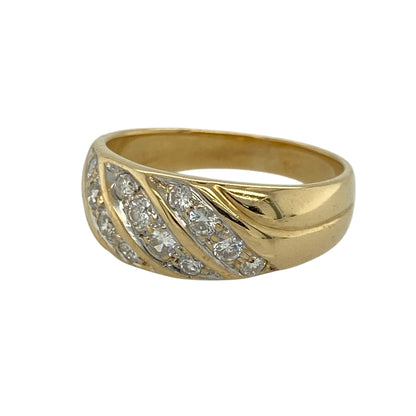 Add bold sparkle and elegant movement to your jewellery collection with this pre-owned 9ct yellow gold diamond band ring, offering eye-catching design with refined brilliance.

Design: This band ring features three rows of diamonds arranged diagonally across the front, creating a dynamic and flowing look that draws the eye. The front of the band measures approximately 7mm in width, giving the ring a confident and elegant presence.