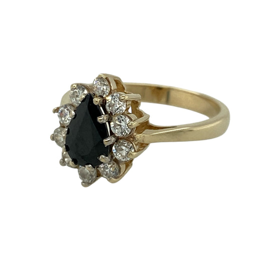 Add rich colour and elegant sparkle to your jewellery collection with this pre-owned 9ct yellow gold sapphire and cubic zirconia teardrop cluster ring, offering a graceful design with classic appeal.

Design: This ring features a teardrop-shaped cluster front centred with a sapphire measuring approximately 8mm by 5mm, surrounded by cubic zirconia that enhance its shape and brilliance.